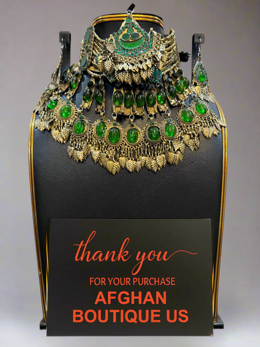 Jewelry set on a black stand with 'thank you' sign from Afghan Boutique US